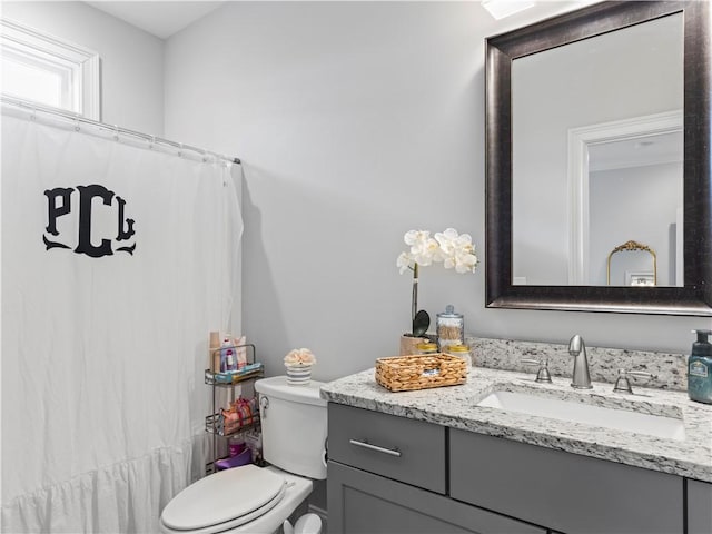 bathroom featuring vanity and toilet