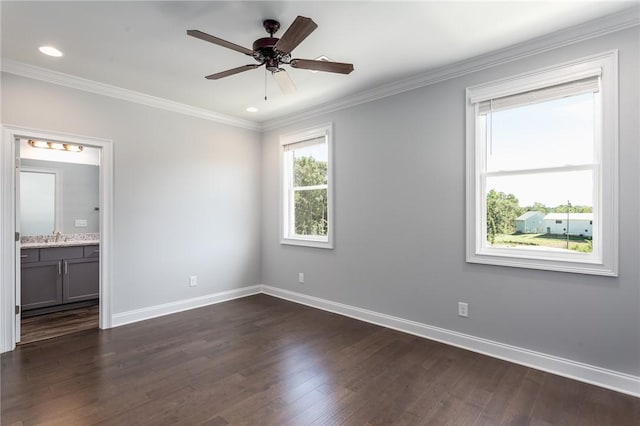 spare room with sink, crown molding, dark hardwood / wood-style floors, and ceiling fan