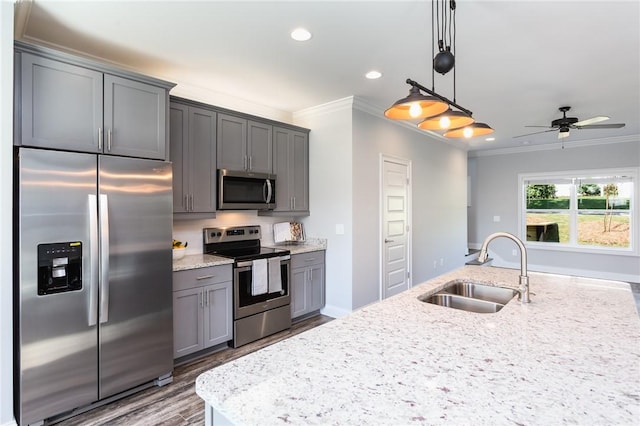 kitchen featuring gray cabinets, appliances with stainless steel finishes, pendant lighting, sink, and ornamental molding