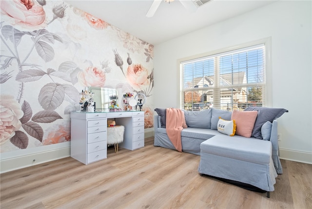 sitting room with light hardwood / wood-style floors and ceiling fan