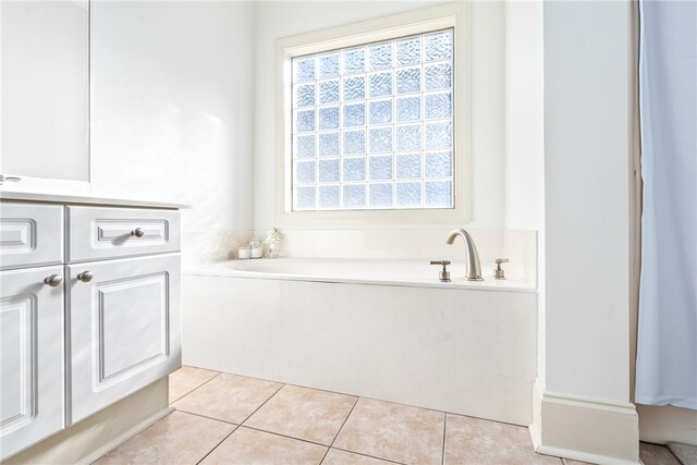 bathroom with vanity, a bathtub, and tile patterned floors