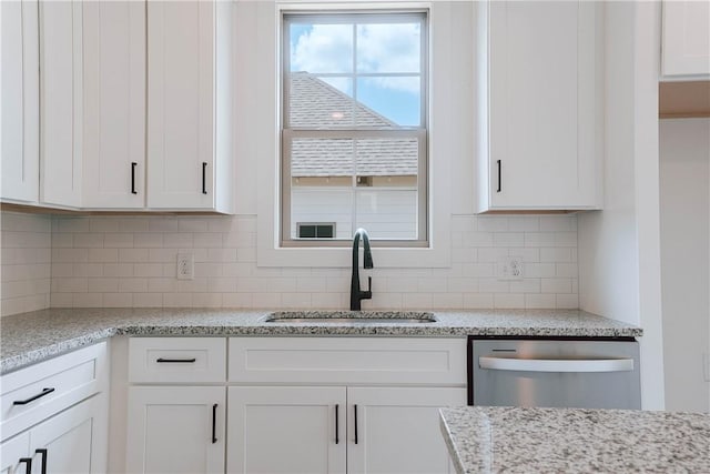7 Crossing Ct E, Valley, AL 36854 - kitchen with stainless steel dishwasher, white cabinetry, tasteful backsplash, and light stone countertops