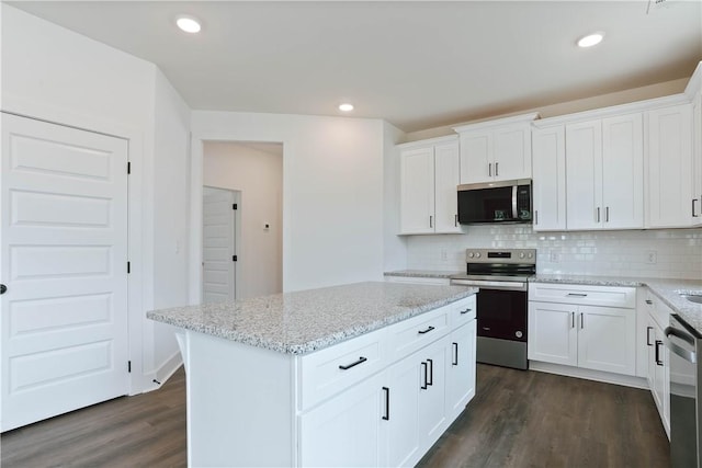 7 Crossing Ct E, Valley, AL 36854 - kitchen with appliances with stainless steel finishes, dark wood-style floors, decorative backsplash, white cabinetry, and recessed lighting