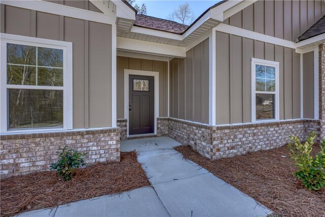 204 Lee Rd Unit 2037, Salem, AL 36874 - view of front facade featuring board and batten siding, concrete driveway, brick siding, an attached garage, and a front yard