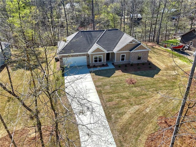 204 Lee Rd Unit 2037, Salem, AL 36874 - view of front of home featuring concrete driveway, a shingled roof, a garage, a front lawn, and board and batten siding