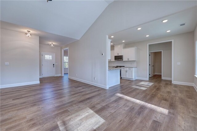 204 Lee Rd Unit 2037, Salem, AL 36874 - unfurnished living room with baseboards, wood finished floors, recessed lighting, and high vaulted ceiling