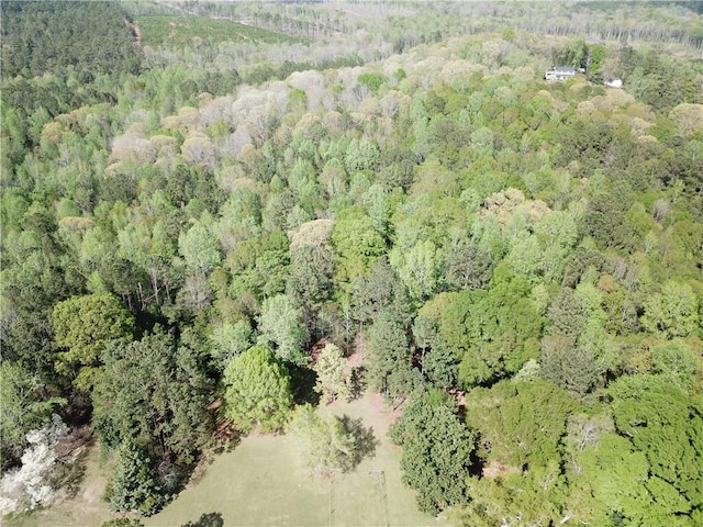 birds eye view of property with a view of trees