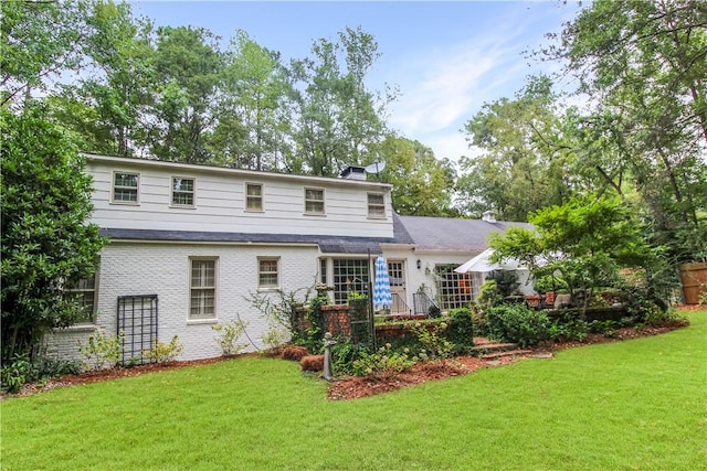 rear view of house with a lawn