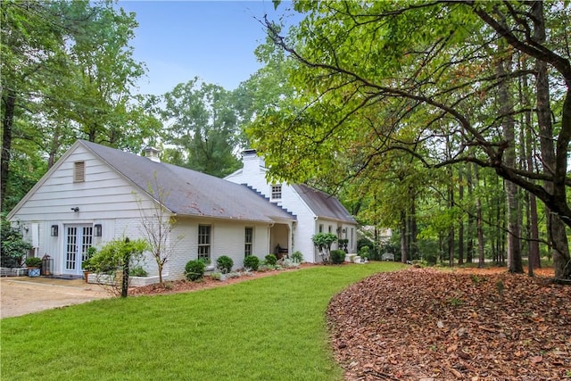 exterior space with a front lawn and french doors