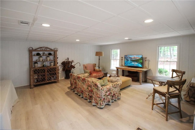 living room with light hardwood / wood-style floors and a healthy amount of sunlight