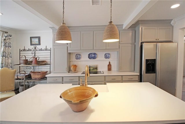 kitchen featuring gray cabinetry, hanging light fixtures, and stainless steel refrigerator with ice dispenser