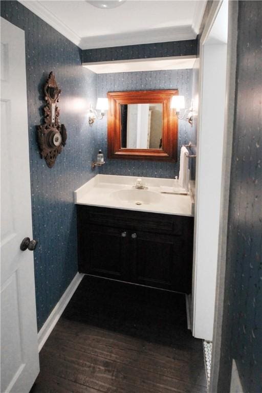 bathroom with vanity, wood-type flooring, and ornamental molding