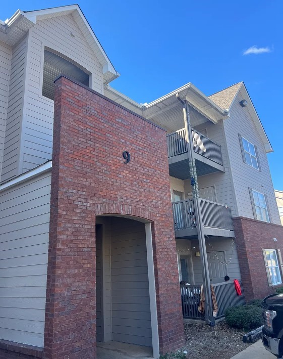 view of side of home with brick siding