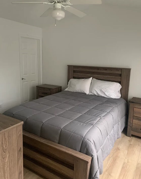 bedroom with light wood-style flooring and a ceiling fan