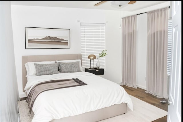 bedroom featuring ceiling fan and wood finished floors