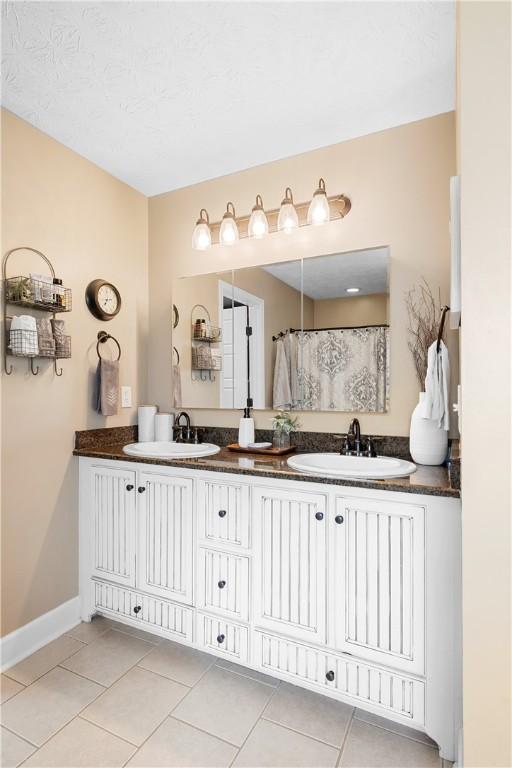 304 Marthas Ct, Opelika, AL 36801 - bathroom with tile patterned flooring, double vanity, and baseboards