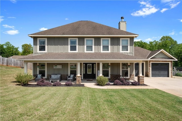 304 Marthas Ct, Opelika, AL 36801 - view of front of house featuring board and batten siding, a chimney, an attached garage, driveway, and an outdoor living space