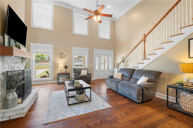 304 Marthas Ct, Opelika, AL 36801 - living room with a ceiling fan, ornamental molding, a stone fireplace, baseboards, and stairway
