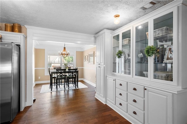 304 Marthas Ct, Opelika, AL 36801 - dining area featuring a chandelier, baseboards, ornamental molding, and dark wood-style floors