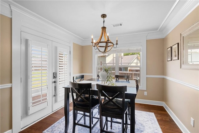 304 Marthas Ct, Opelika, AL 36801 - dining area featuring a chandelier, ornamental molding, dark wood-type flooring, and baseboards