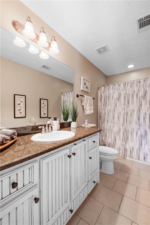 304 Marthas Ct, Opelika, AL 36801 - full bath featuring toilet, vanity, tile patterned floors, and curtained shower