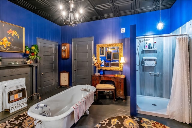 bathroom featuring a notable chandelier, a freestanding bath, heating unit, a stall shower, and an ornate ceiling