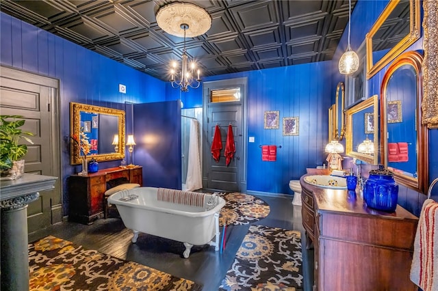 interior space with an ornate ceiling, dark wood-style flooring, baseboards, and an inviting chandelier