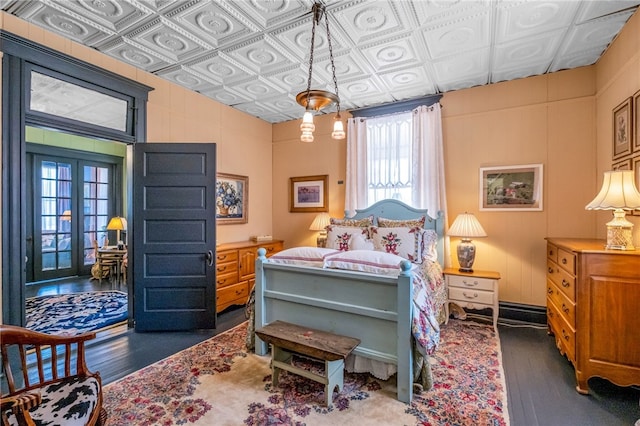 bedroom featuring dark wood finished floors and an ornate ceiling