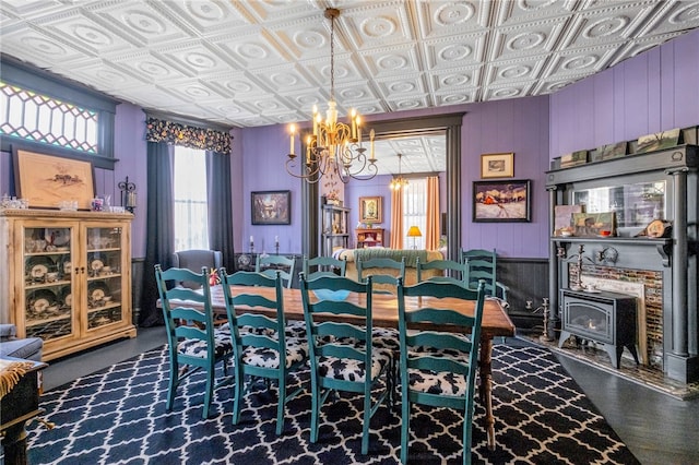 117 N Lafayette St, Lafayette, AL 36862 - dining space with a wood stove, a chandelier, an ornate ceiling, and wood walls