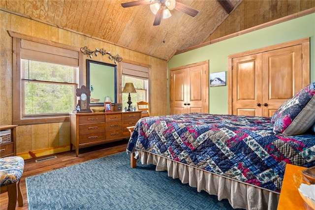 1515 County Road 63, Tuskegee, AL 36083 - bedroom with vaulted ceiling, wood ceiling, two closets, wood finished floors, and wood walls