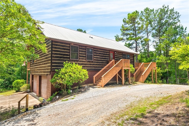 1515 County Road 63, Tuskegee, AL 36083 - view of front of home featuring driveway, stairs, a garage, and a metal roof
