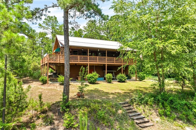 1515 County Road 63, Tuskegee, AL 36083 - rear view of property featuring a wooden deck, a metal roof, and a yard