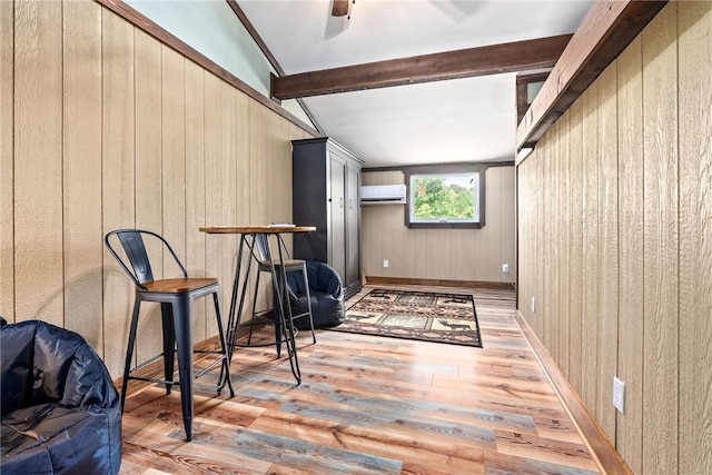 1515 County Road 63, Tuskegee, AL 36083 - living area with an AC wall unit, wood finished floors, wood walls, and a ceiling fan