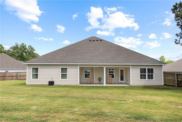 rear view of house featuring a patio, a shingled roof, and central air condition unit
