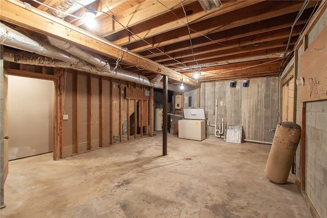 basement featuring gas water heater and washer / clothes dryer