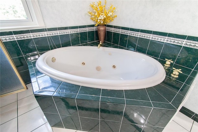 bathroom with tile patterned flooring and tiled bath