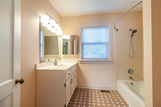 bathroom featuring vanity and tiled shower / bath