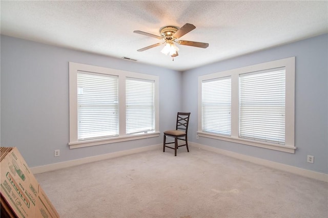 sitting room featuring light colored carpet and ceiling fan