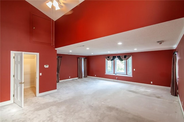 carpeted empty room with vaulted ceiling, ceiling fan, and ornamental molding