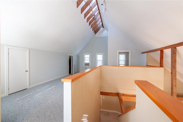 stairs featuring carpet flooring and lofted ceiling