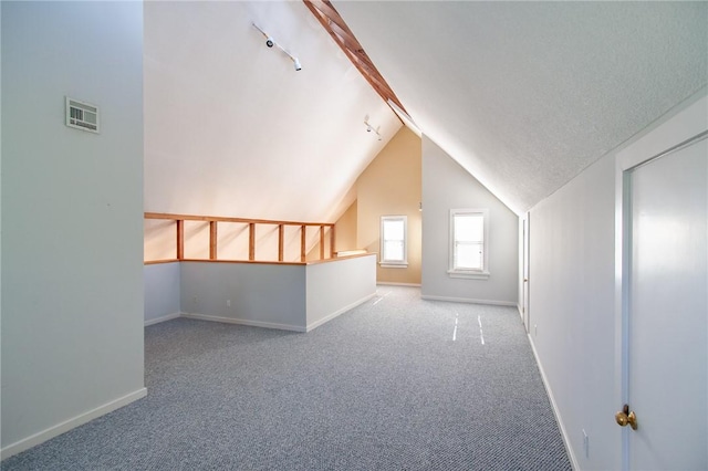 bonus room with a textured ceiling, carpet floors, and vaulted ceiling