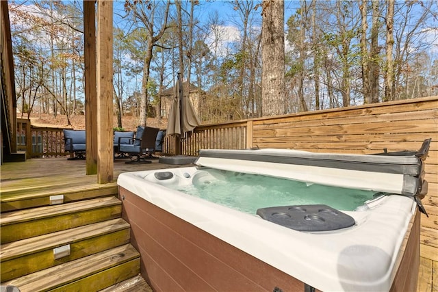 view of pool with a hot tub and a deck