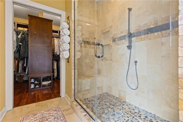 bathroom featuring tile patterned floors and a shower with shower door