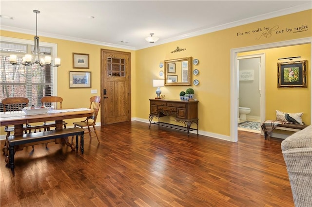 dining space with dark wood-type flooring, ornamental molding, and a notable chandelier