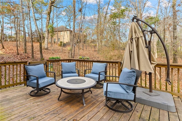 wooden deck with an outdoor fire pit