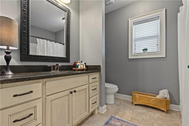 bathroom with vanity, tile patterned floors, and toilet