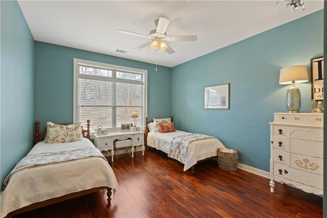 bedroom with ceiling fan and dark hardwood / wood-style flooring