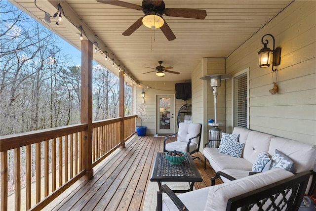 wooden deck featuring an outdoor hangout area and ceiling fan