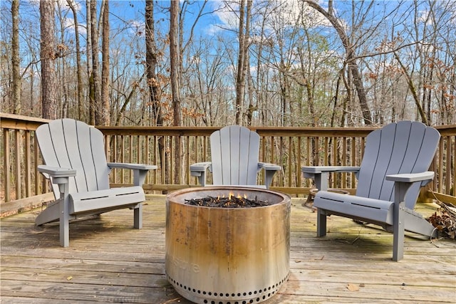 wooden terrace featuring an outdoor fire pit