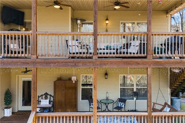 exterior space featuring ceiling fan and a balcony